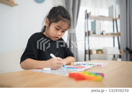Young Girl Engaged in Creative Drawing Activity at Home with Colorful Markers and Paper in Bright, Cozy Indoor Environment Young Girl Engaged in Creative Drawing Activity at Home with Colorful Markers and Paper in Bright, Cozy Indoor Environment 132938250