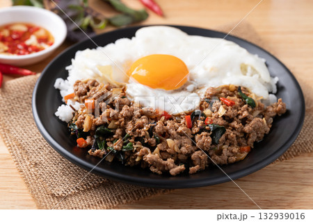 Thai food, Stir fried holy basil with minced pork with cooked rice and fried egg on top Thai food, Stir fried holy basil with minced pork with cooked rice and fried egg on top 132939016
