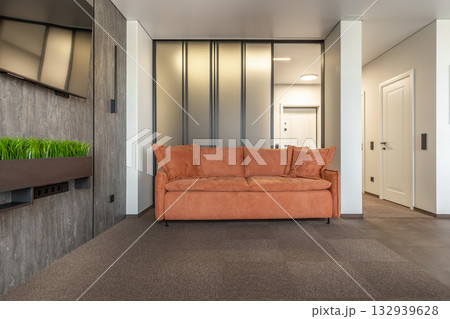 Modern Living Room with Orange Sofa and Sliding Glass Partition Modern Living Room with Orange Sofa and Sliding Glass Partition 132939628