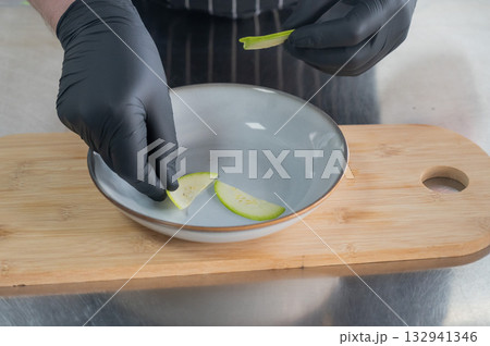 The chef lays out the salad. The chef lays out the salad. 132941346