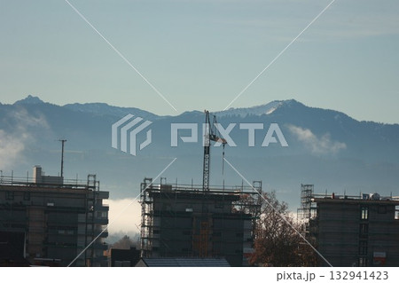 Construction Site in Valley with Snowy Mountains Construction Site in Valley with Snowy Mountains 132941423