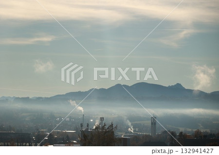 Misty mountain valley with town and church tower at sunrise 132941427