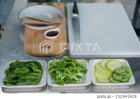 Making a flatbread with herbs in a cafe.  132941429