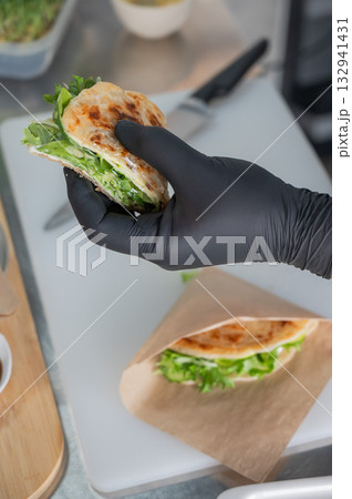 The chef prepares a flatbread with herbs.  132941431