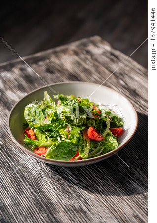 Green salad served in a cafe. Green salad served in a cafe. 132941446