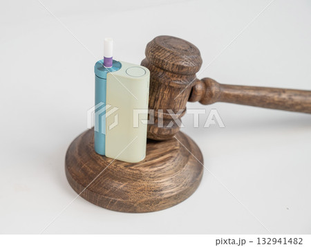 Judge's gavel and e-cigarette. Smoking ban. Tobacco heating systems.  132941482