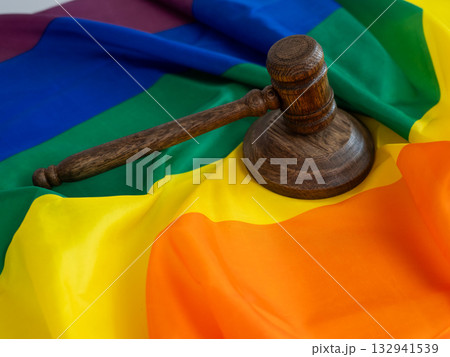 Judge's gavel and hammer on a rainbow flag. Judge's gavel and hammer on a rainbow flag. 132941539