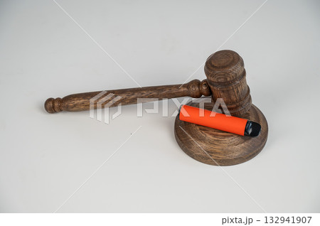 Judge's gavel and e-cigarette. Smoking ban. Tobacco heating systems.  132941907