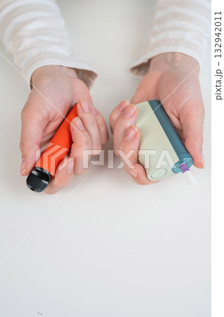 Woman holding electronic cigarette and disposable vape on white background. Tobacco heating systems and vaporizer.  132942011