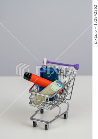 Electronic cigarette and disposable vape in a shopping cart. Tobacco heating systems and vaporizer. Electronic cigarette and disposable vape in a shopping cart. Tobacco heating systems and vaporizer. 132942262