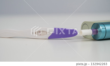 Pregnancy test and electronic cigarette on white table. Pregnancy test and electronic cigarette on white table. 132942263