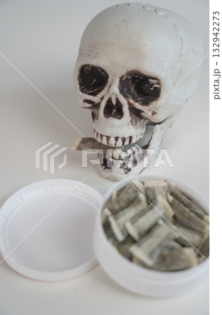 Skull Chewing Tobacco on a White Table. Skull Chewing Tobacco on a White Table. 132942273