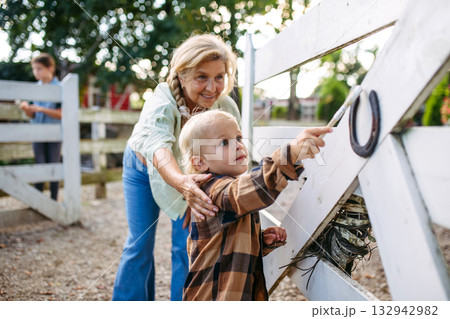 Little boy helping on farm, painting fence. Little boy helping on farm, painting fence. 132942982
