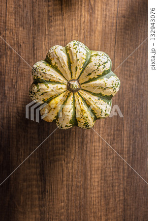 Sweet dumpling pumpkin on wooden table. Top view. Sweet dumpling pumpkin on wooden table. Top view. 132943076