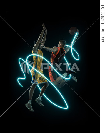 Two basketball players in mid-air duel surrounded by neon light trails 132944151