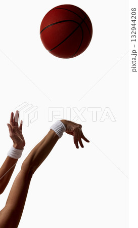 Female athlete releasing basketball in dynamic shooting motion Female athlete releasing basketball in dynamic shooting motion 132944208