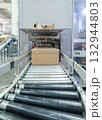 packing line in a logistics warehouse. conveyor belt in a modern production line 132944803