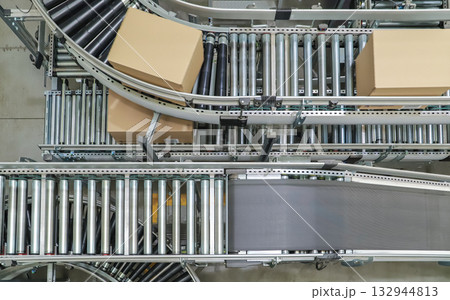 packing line in a logistics warehouse. conveyor belt in a modern production line 132944813