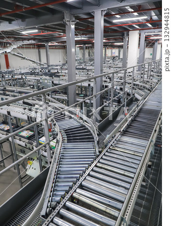 packing line in a logistics warehouse. conveyor belt in a modern production line packing line in a logistics warehouse. conveyor belt in a modern production line 132944815