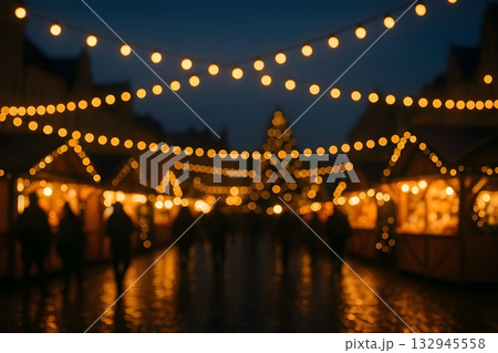 Defocused Christmas market at night with warm golden string lights, glowing stalls 132945558