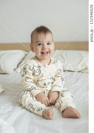 Joyful baby in bear print pajamas 132946026
