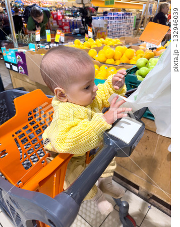 Baby in Yellow Sweater at Grocery Store 132946039