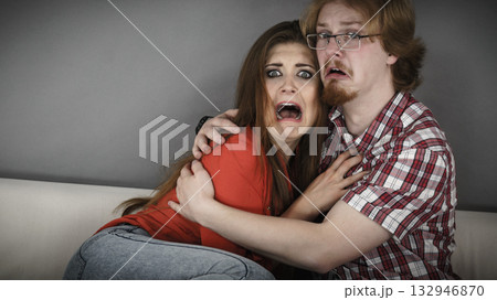 Funny couple watching horror movie Funny couple watching horror movie 132946870