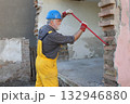 Adult worker demolish old house 132946880