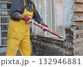 Adult worker demolish old house 132946881