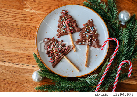 Chocolate Christmas tree candies, festive sweets for holiday table 132946973