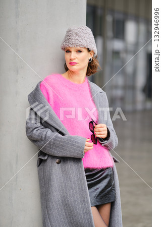 Stylish woman in urban street fashion with colorful outfit and sunglasses in modern city setting Stylish woman in urban street fashion with colorful outfit and sunglasses in modern city setting 132946996