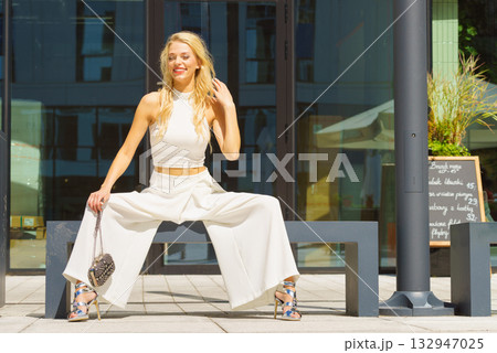 Woman wearing crop top and culottes Woman wearing crop top and culottes 132947025