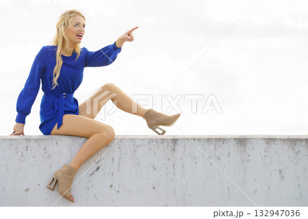 Fashion model wearing blue jumpsuit Fashion model wearing blue jumpsuit 132947036