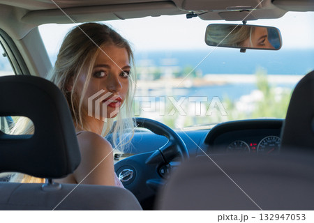 Young driver woman behind steering wheel 132947053