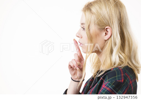 Woman showing silence gesture Woman showing silence gesture 132947356