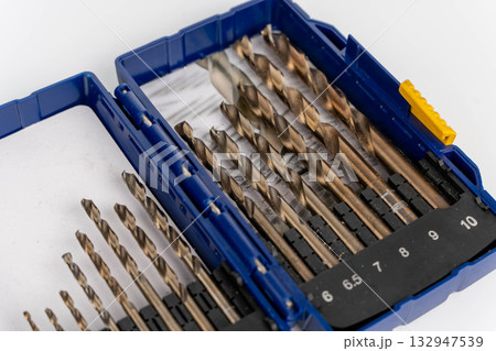 High-quality drill bit set in a blue case, featuring various sizes and shapes, showcasing precision engineering and essential tools for woodworking and metalworking projects High-quality drill bit set in a blue case, featuring various sizes and shapes, showcasing precision engineering and essential tools for woodworking and metalworking projects 132947539