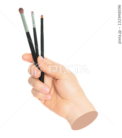 Woman hand holds black cosmetics brush, isolated on transparent background, cosmetics and visage concept. Contemporary art 132948096
