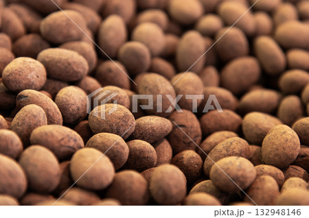 Close-up of brown dragee, chocolate covered nuts, sweet candy background. 132948146