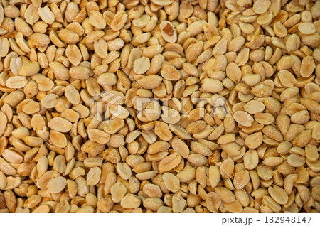 A background of salted roasted peanuts. Lots of peeled peanuts, top view. 132948147