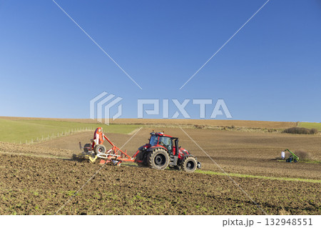 Red tractor plowing field in Liptovsky Mikulas, Slovakia 132948551