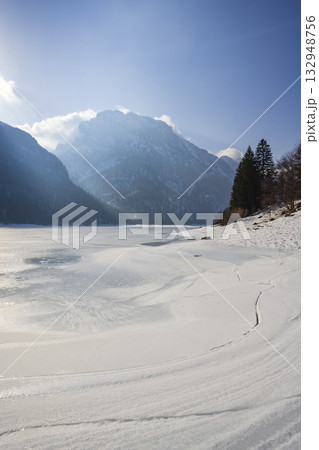 Frozen Lago del Predil with mountains surrounding it Frozen Lago del Predil with mountains surrounding it 132948756