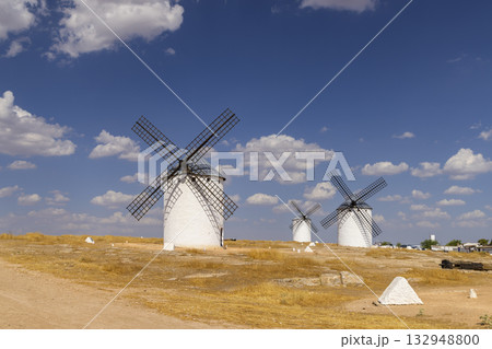 White windmills standing on arid landscape in Campo de Criptana White windmills standing on arid landscape in Campo de Criptana 132948800