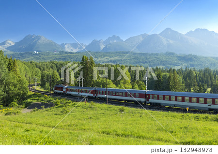 Train traveling through the Slovak mountains in Strba Train traveling through the Slovak mountains in Strba 132948978