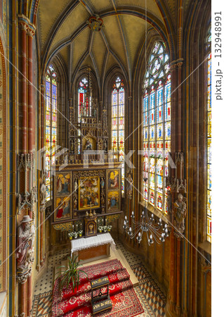 Gothic church interior with colourful stained glass windows in Slovakia Gothic church interior with colourful stained glass windows in Slovakia 132948991