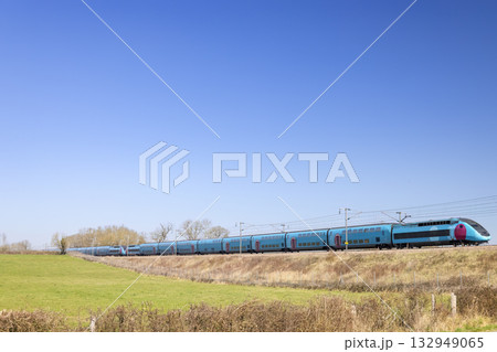 High speed passenger train traveling through the French countryside 132949065