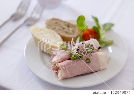 Ham rolls with microgreens, bread, and cherry tomato Ham rolls with microgreens, bread, and cherry tomato 132949074