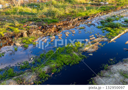 Water filled with pollution and garbage poses a serious threat to the local environment and surrounding wildlife in this area Water filled with pollution and garbage poses a serious threat to the local environment and surrounding wildlife in this area 132950097