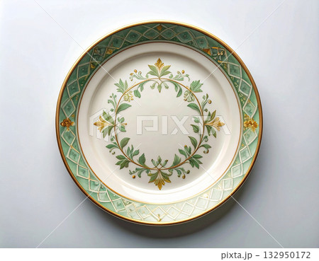 Vintage patterns. Ceramic plate with a green and gold pattern on a white background. Porcelain kitchenware. Close-up. Top view. 132950172