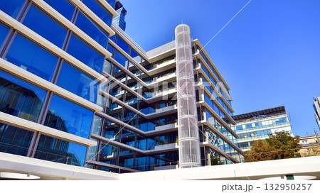 Exterior of modern high-rise buildings in a business district. Tall office buildings. Glass-fronted skyscrapers. Modern business district. 132950257