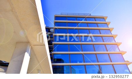 Exterior of modern high-rise buildings in a business district. Tall office buildings. Glass-fronted skyscrapers. Modern business district. 132950277